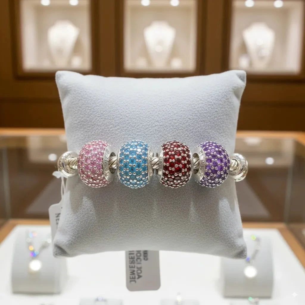 Bracelet with colorful beads on a gray pillow in a jewelry store setting