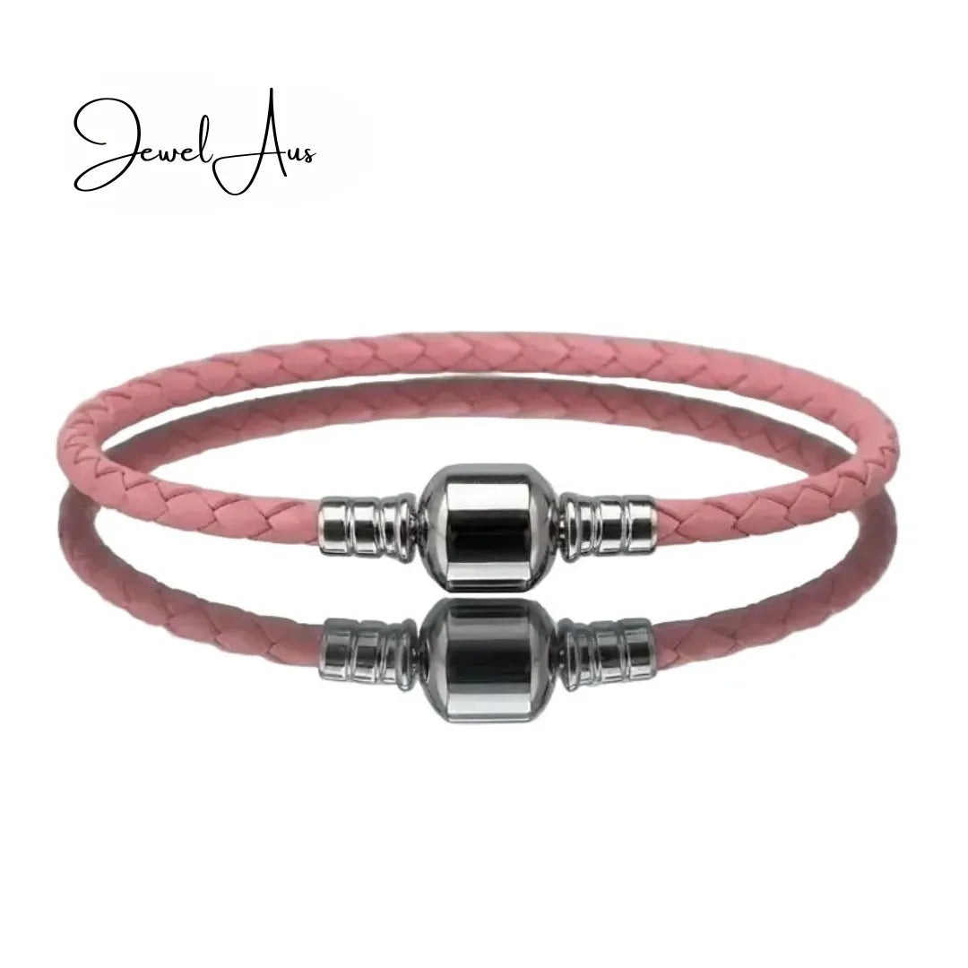 Pink braided leather bracelet with silver beads on a white background, featuring the brand 'Jewel Aus'.