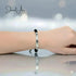 Bracelet on a wrist with a blurred background, featuring the brand 'Jewel A'.