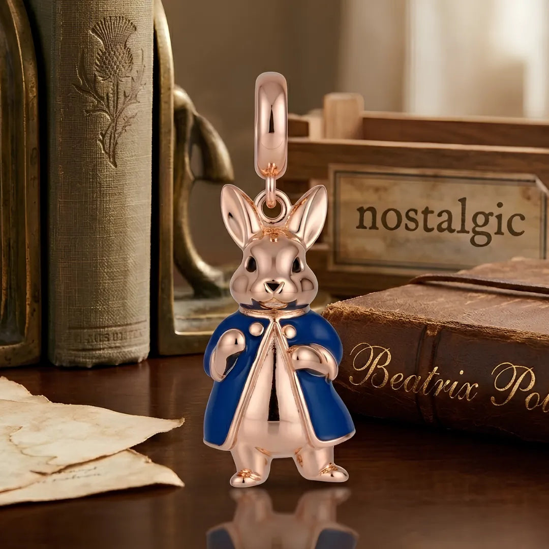 Charm resembling a rabbit in a blue coat on a reflective surface with books and a 'nostalgic' sign in the background.
